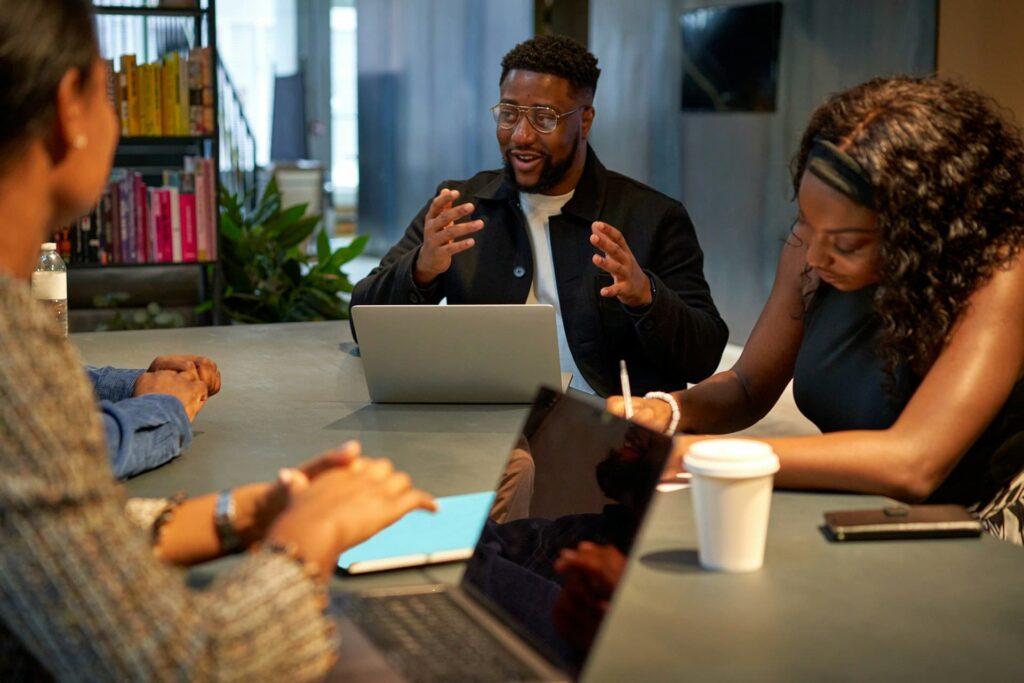 A black founder in a meeting with his team